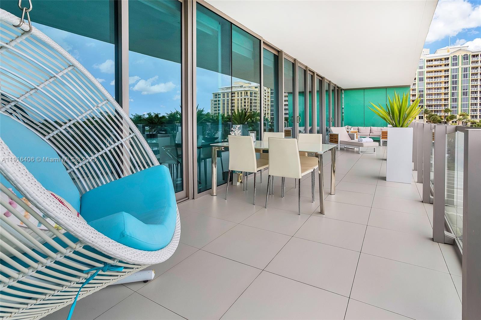 350 Ocean Drive, Unit 405N Key Biscayne, FL 33149 - Photo 19 of 34 a view of a patio with a table chairs and backyard