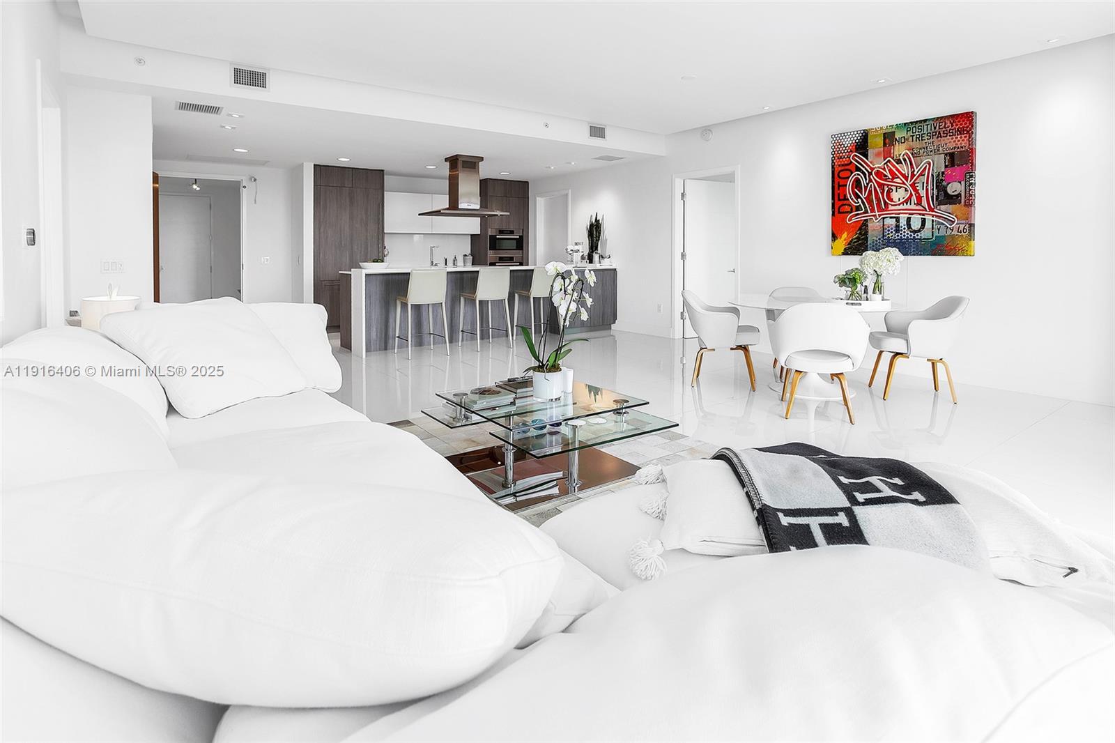 350 Ocean Drive, Unit 405N Key Biscayne, FL 33149 - Photo 2 of 34 a living room with furniture a table and kitchen view