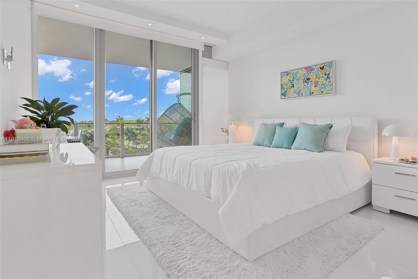 350 Ocean Drive, Unit 405N Key Biscayne, FL 33149 - Photo 23 of 34 a bedroom with a large bed and a large window