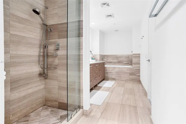 a bathroom with a glass shower door