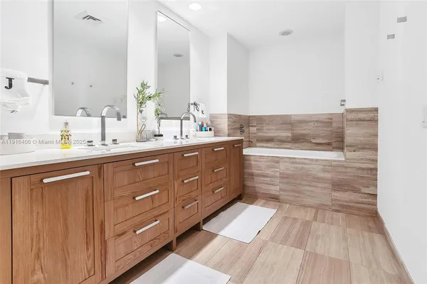 a bathroom with a double vanity sink and mirror