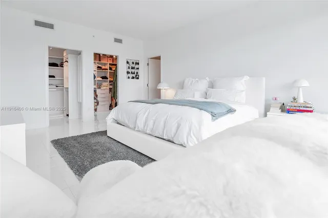 a bedroom with a large bed and a couch