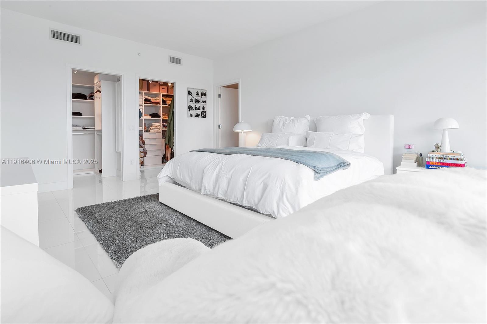 350 Ocean Drive, Unit 405N Key Biscayne, FL 33149 - Photo 29 of 34 a bedroom with a large bed and a couch