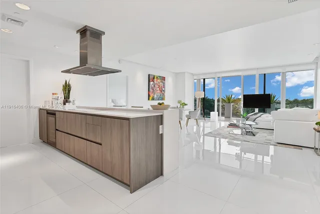 a kitchen with stainless steel appliances kitchen island granite countertop a sink and a stove