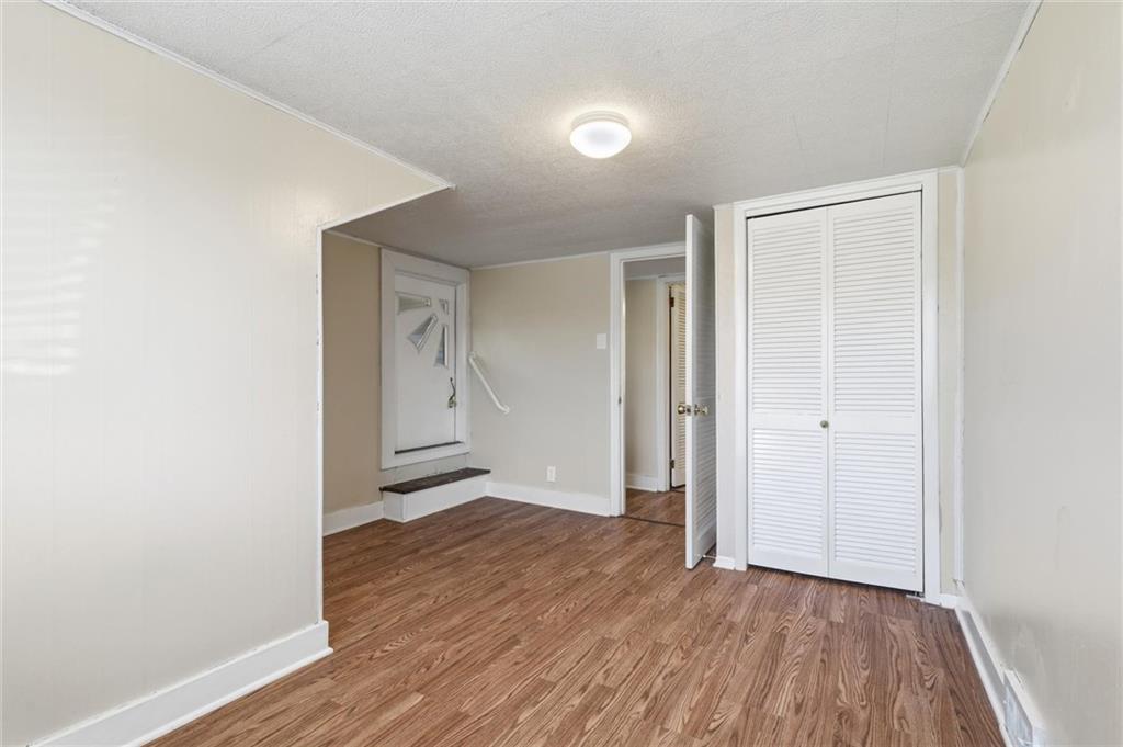 54 Terrace Road Millsboro, PA 15348 - Photo 30 of 49 an empty room with wooden floor and windows