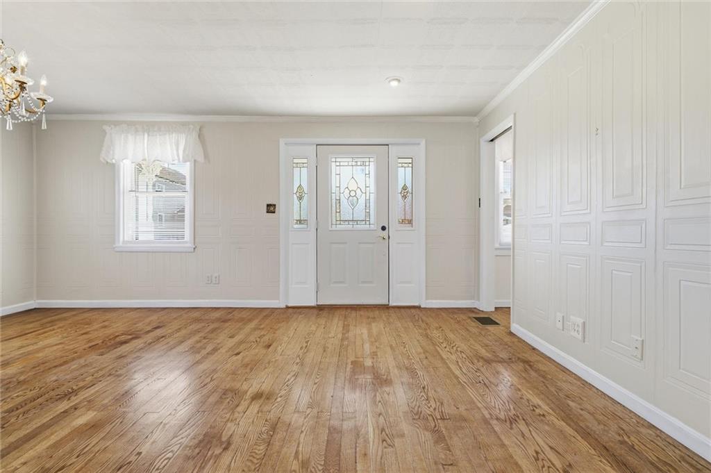 54 Terrace Road Millsboro, PA 15348 - Photo 5 of 49 a view of an empty room with wooden floor and a window