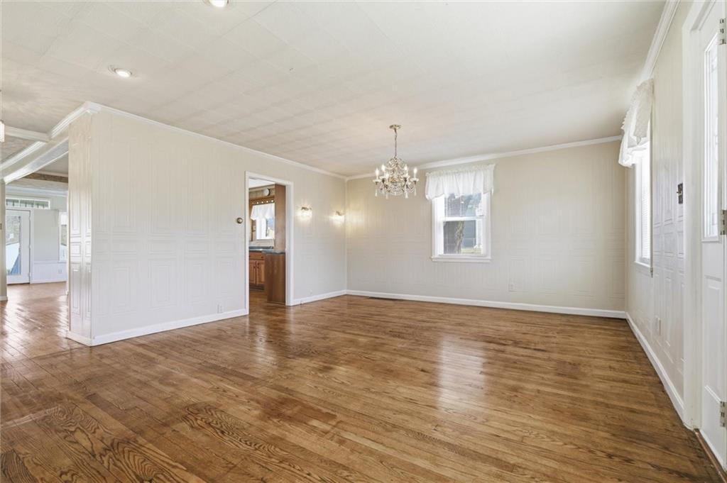 54 Terrace Road Millsboro, PA 15348 - Photo 7 of 49 an empty room with wooden floor chandelier and windows