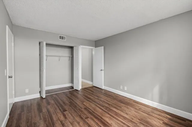a view of room with wooden floor