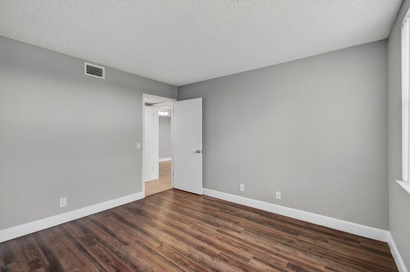 744 Executive Center Drive, Unit 11 West Palm Beach, FL 33401 - Photo 15 of 29 a view of an empty room with wooden floor