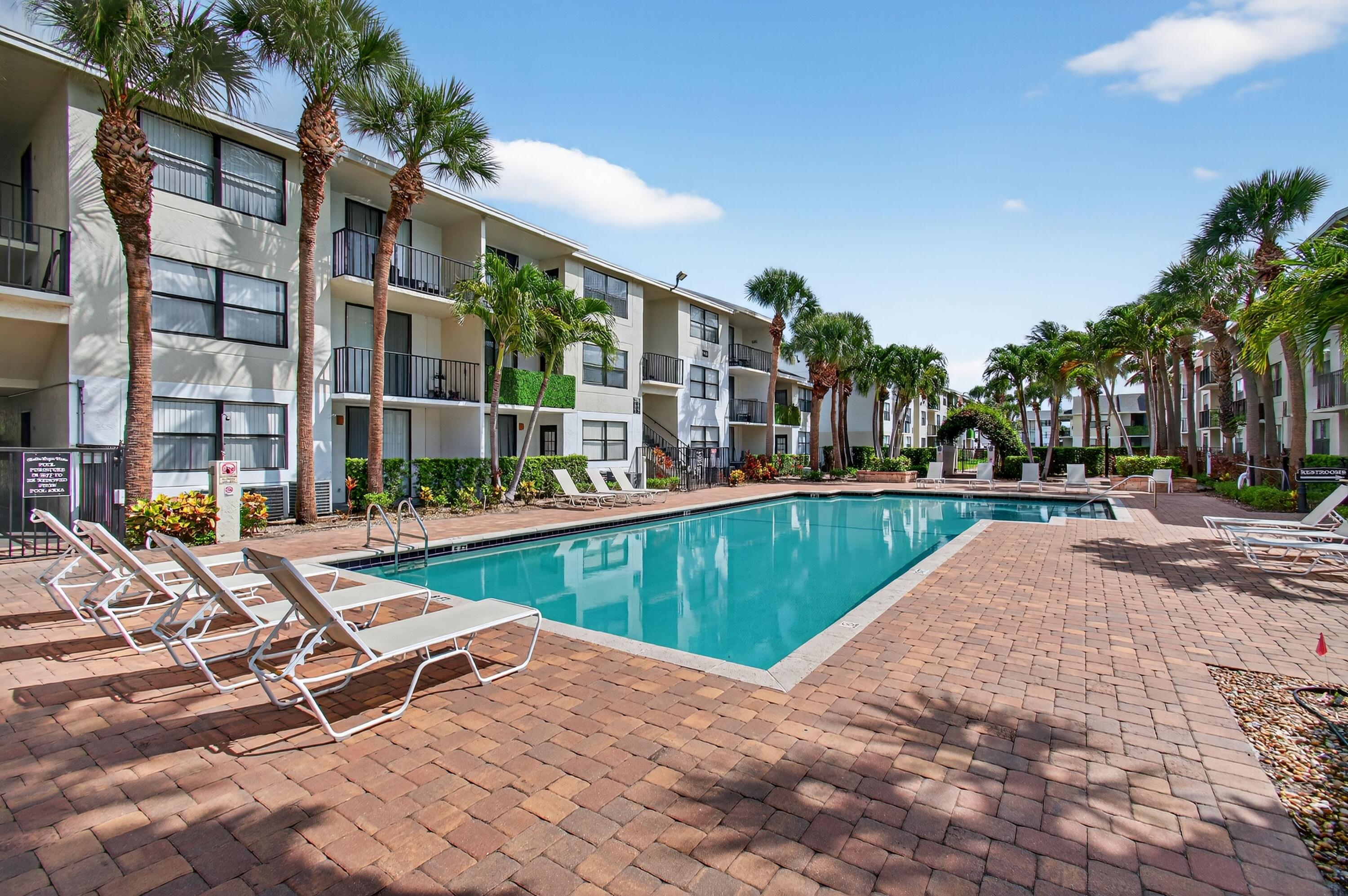 744 Executive Center Drive, Unit 11 West Palm Beach, FL 33401 - Photo 21 of 29 a view of swimming pool with outdoor seating and plants