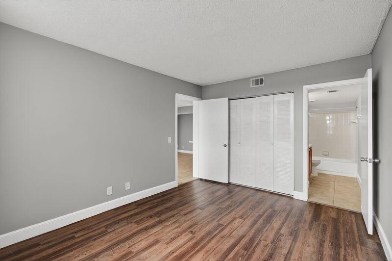 744 Executive Center Drive, Unit 11 West Palm Beach, FL 33401 - Photo 10 of 29 a view of an empty room and wooden floor