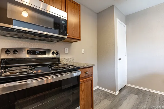 a stove top oven sitting inside of a kitchen