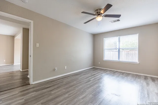 wooden floor in an empty room with a window