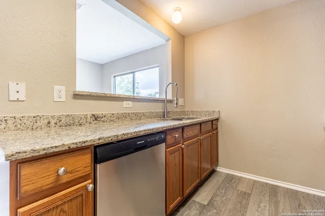 a sink and dishwasher with granite countertop