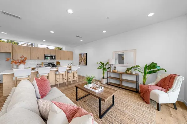 a living room with furniture kitchen and a table
