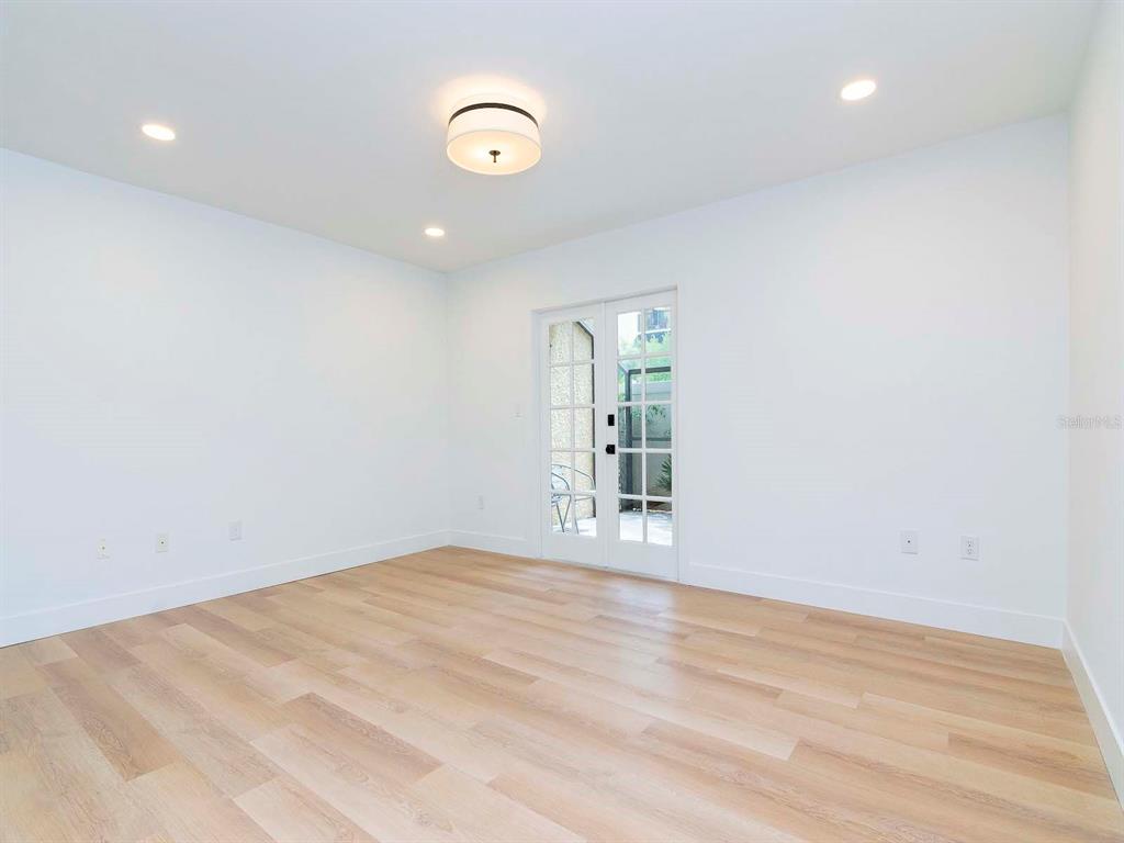 107 South Obrien Street, Unit 118 Tampa, FL 33609 - Photo 15 of 30 a view of an empty room with wooden floor and a window