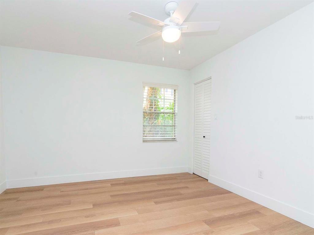 107 South Obrien Street, Unit 118 Tampa, FL 33609 - Photo 23 of 30 an empty room with wooden floor and windows