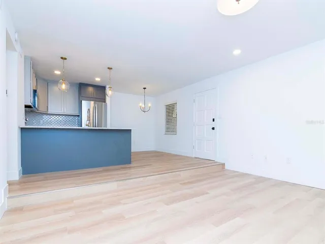 a view of kitchen and empty room