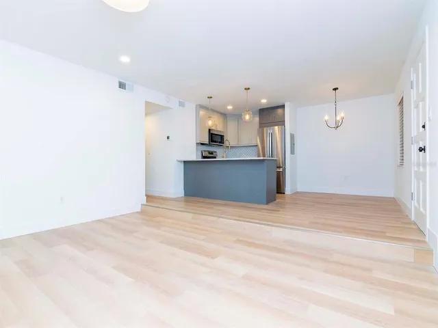 a view of a kitchen with a sink and a refrigerator