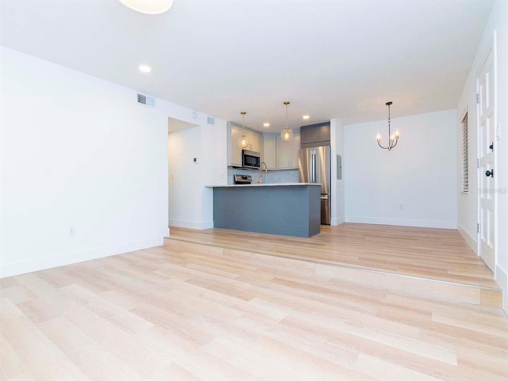 107 South Obrien Street, Unit 118 Tampa, FL 33609 - Photo 4 of 30 a view of a kitchen with a sink and a refrigerator