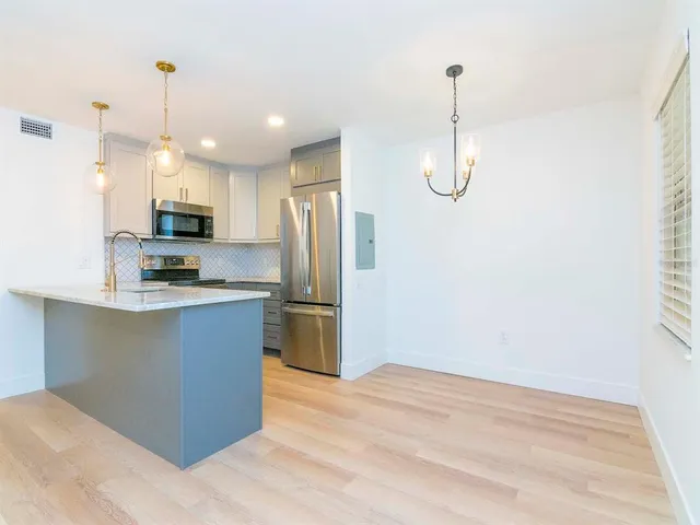 a kitchen with refrigerator and microwave