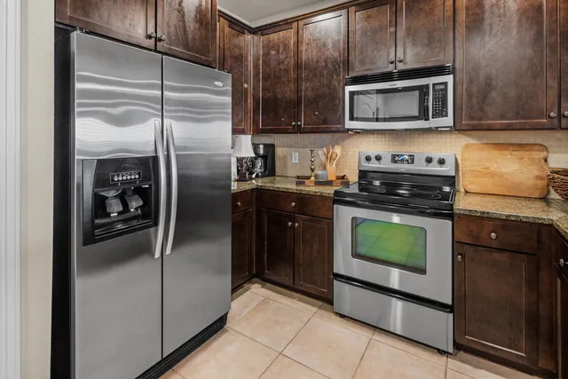 a kitchen with a refrigerator stove and microwave