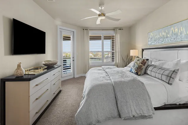 a bedroom with double bed and a flat screen tv