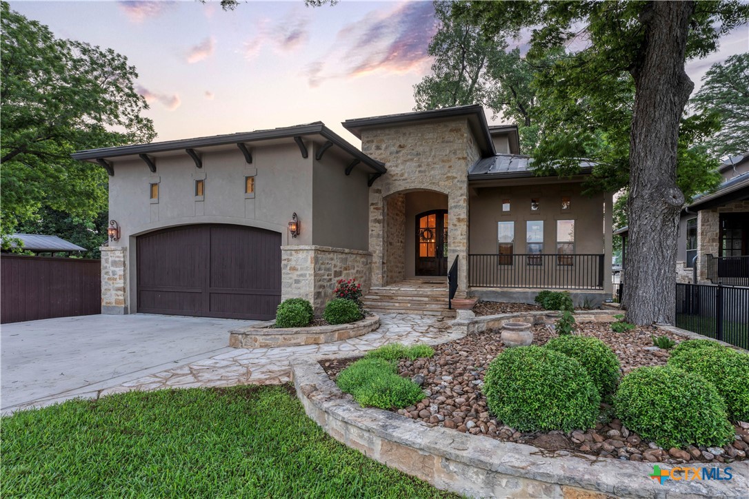 368 Rancho Road New Braunfels, TX 78130 - Photo 1 of 47 a front view of a house with a garden and plants