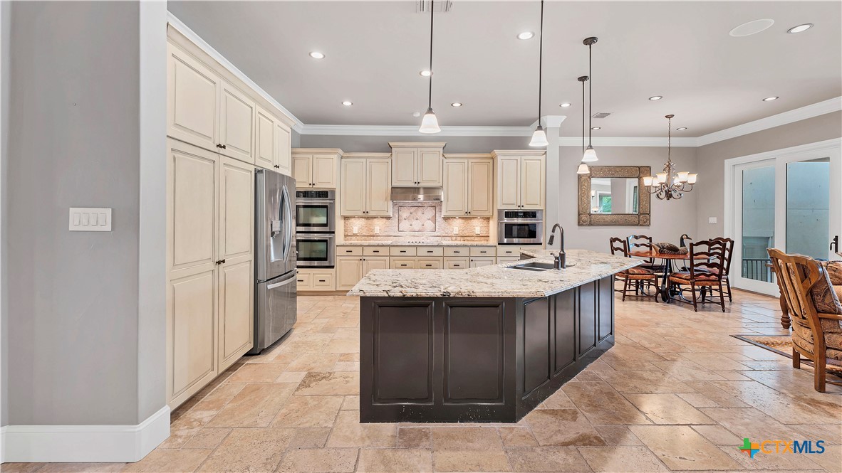 368 Rancho Road New Braunfels, TX 78130 - Photo 11 of 47 a large kitchen with kitchen island a sink stainless steel appliances and cabinets
