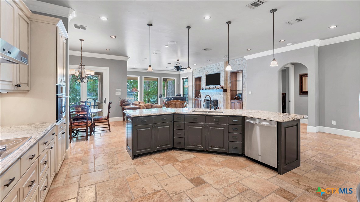 368 Rancho Road New Braunfels, TX 78130 - Photo 14 of 47 a kitchen with stainless steel appliances granite countertop a stove a sink a oven and a refrigerator