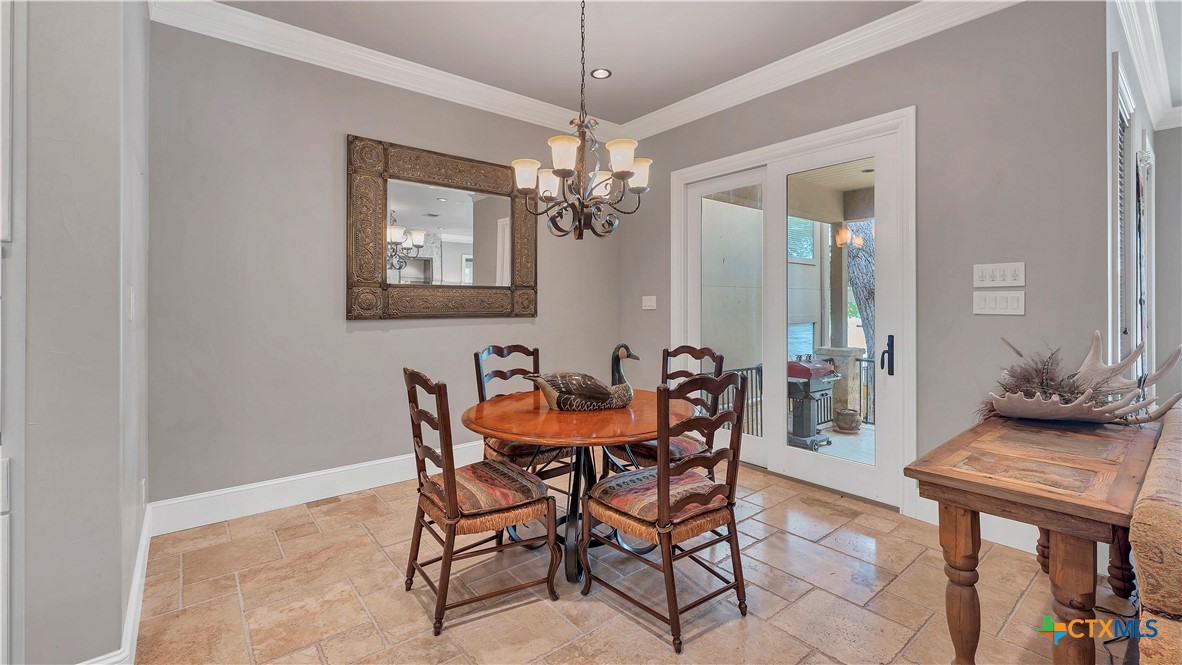 368 Rancho Road New Braunfels, TX 78130 - Photo 22 of 47 a view of a dining room with furniture and a chandelier