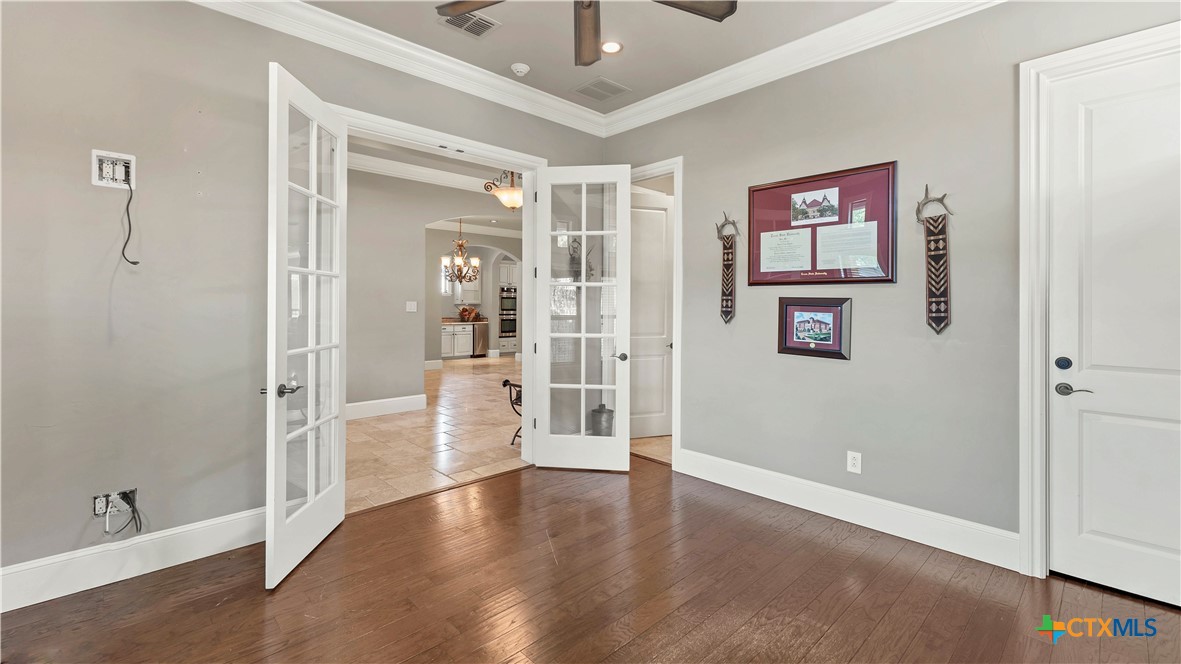368 Rancho Road New Braunfels, TX 78130 - Photo 25 of 47 a view of a hallway with wooden floor and cabinet