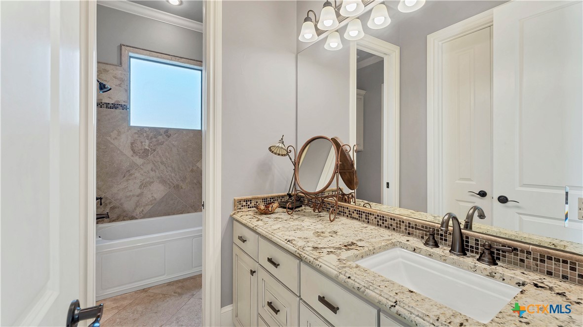 368 Rancho Road New Braunfels, TX 78130 - Photo 30 of 47 a bathroom with a sink and a mirror