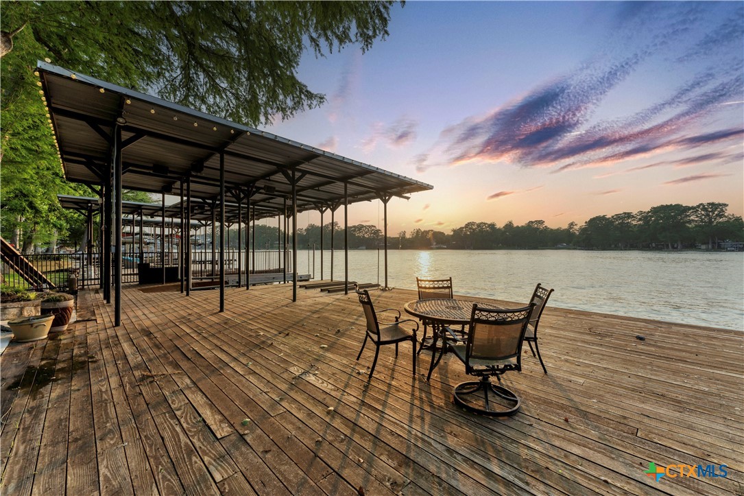 368 Rancho Road New Braunfels, TX 78130 - Photo 40 of 47 a view of a roof deck with table and chairs under an umbrella