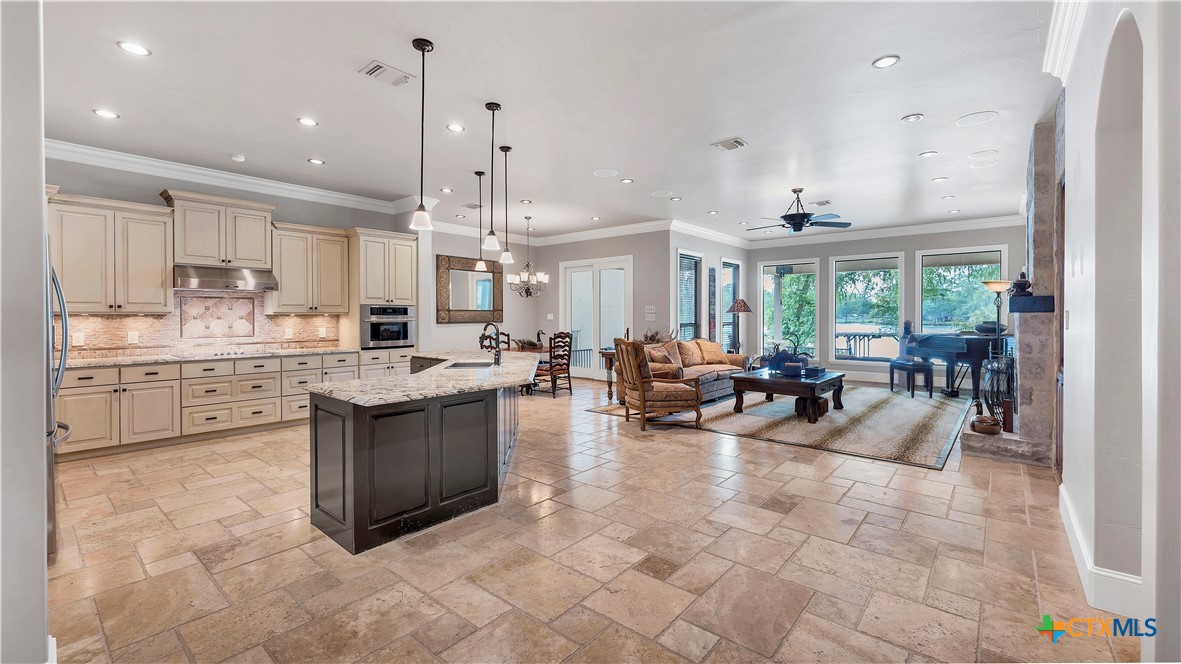 368 Rancho Road New Braunfels, TX 78130 - Photo 5 of 47 a large white kitchen with lots of counter space dining table and chairs
