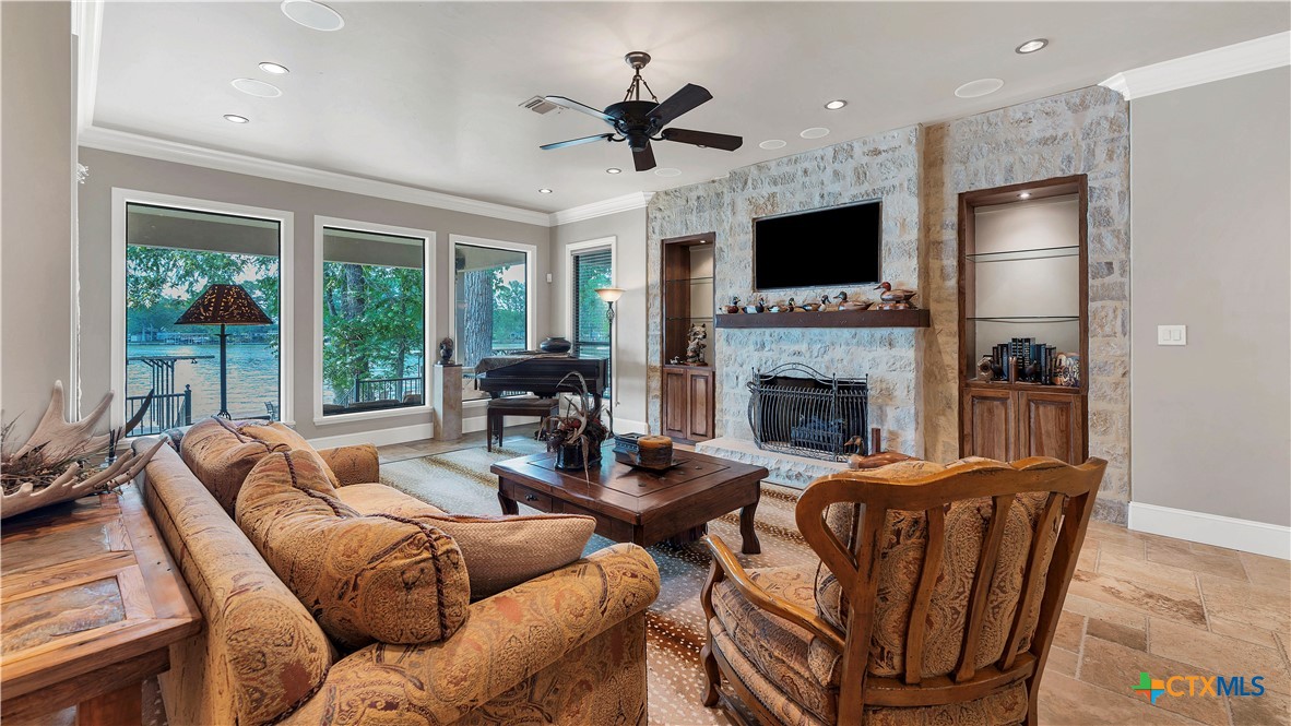 368 Rancho Road New Braunfels, TX 78130 - Photo 8 of 47 a living room with furniture a flat screen tv and a fireplace