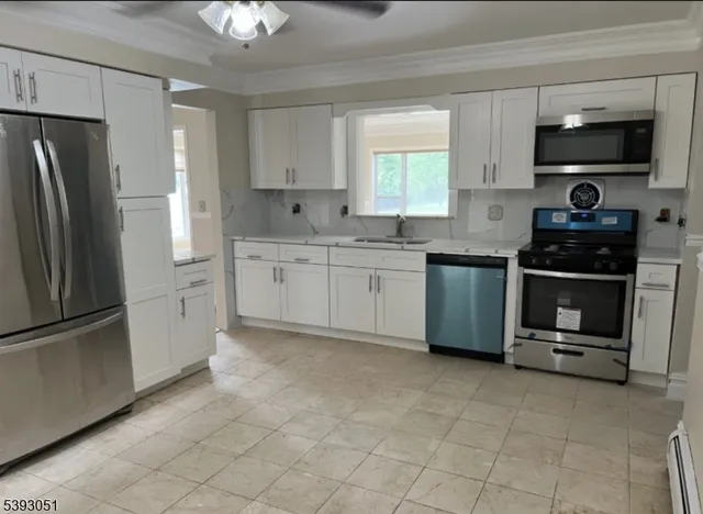 a kitchen with stainless steel appliances granite countertop a refrigerator and a stove