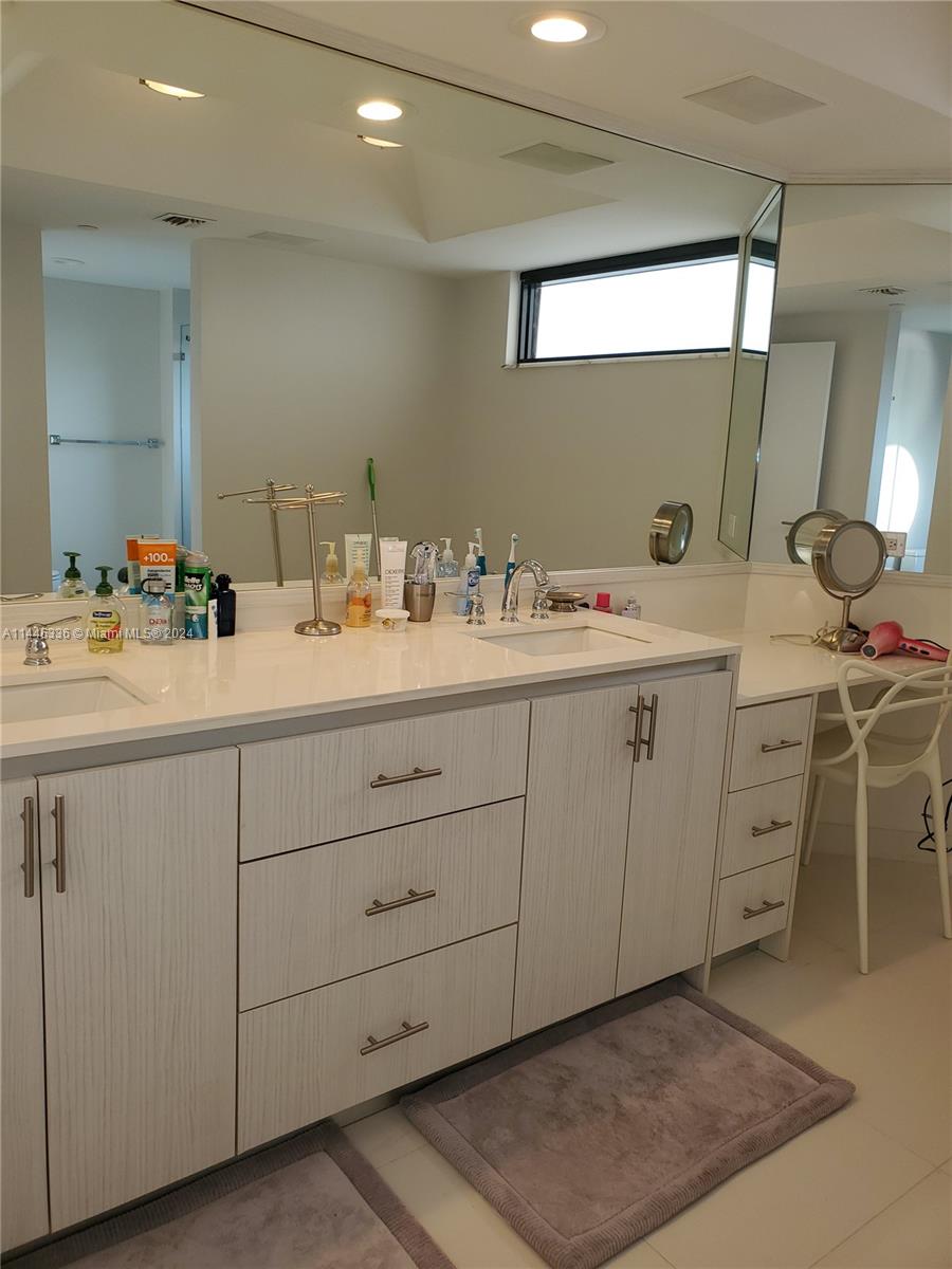 3000 Island Boulevard, Unit 2603 Aventura, FL 33160 - Photo 14 of 28 a utility room with a sink a window and washer