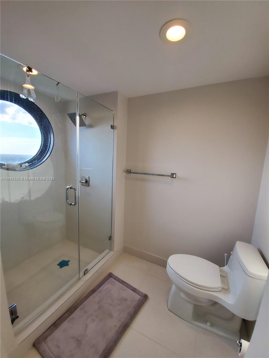 3000 Island Boulevard, Unit 2603 Aventura, FL 33160 - Photo 15 of 28 a bathroom with a shower a toilet and a sink