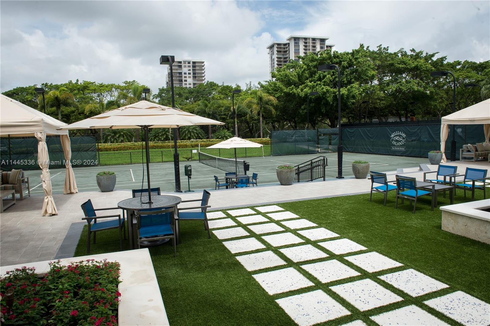 3000 Island Boulevard, Unit 2603 Aventura, FL 33160 - Photo 20 of 28 a view of a house with backyard sitting area and garden