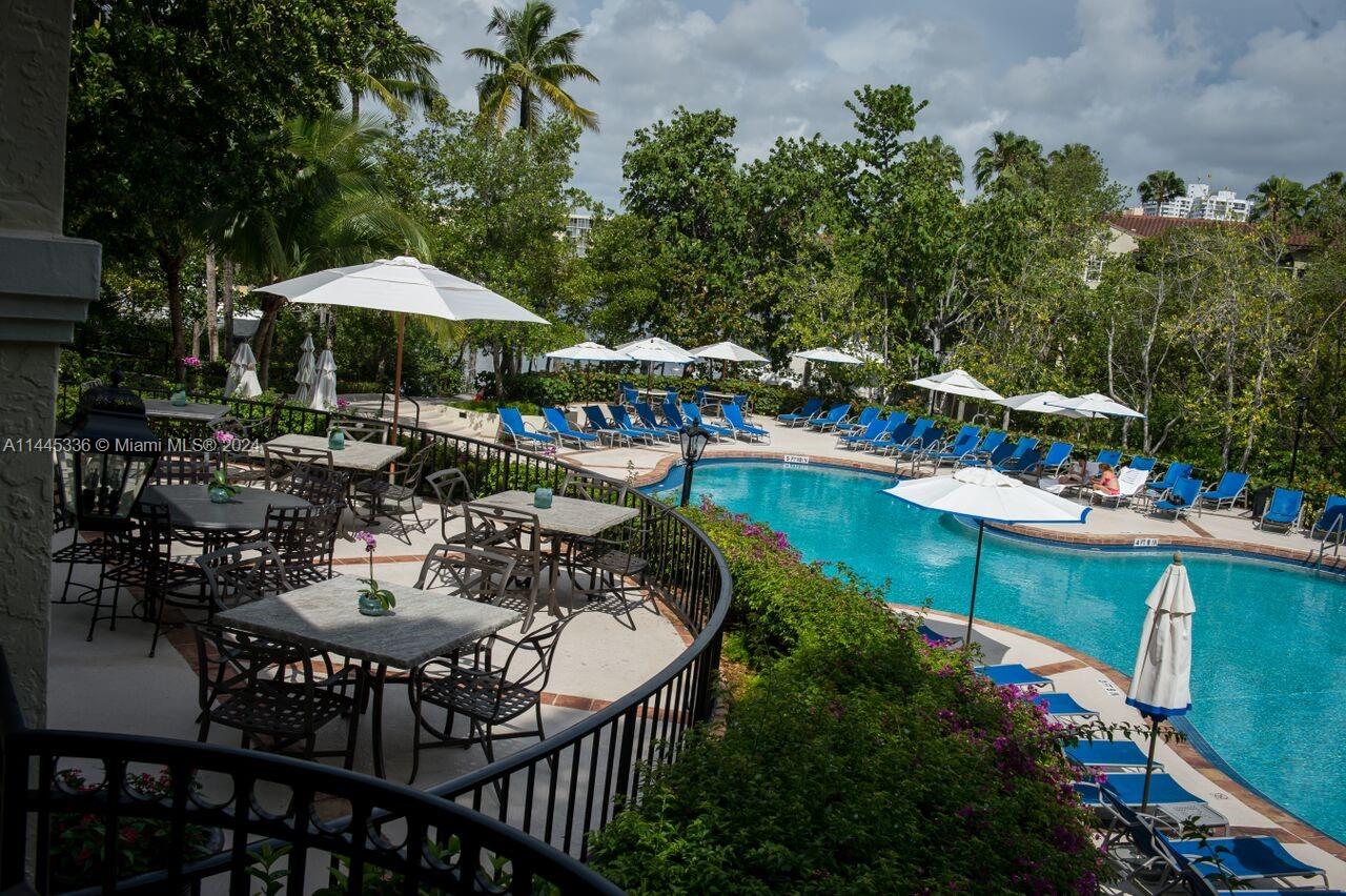 3000 Island Boulevard, Unit 2603 Aventura, FL 33160 - Photo 22 of 28 a view of a chairs and table in the patio