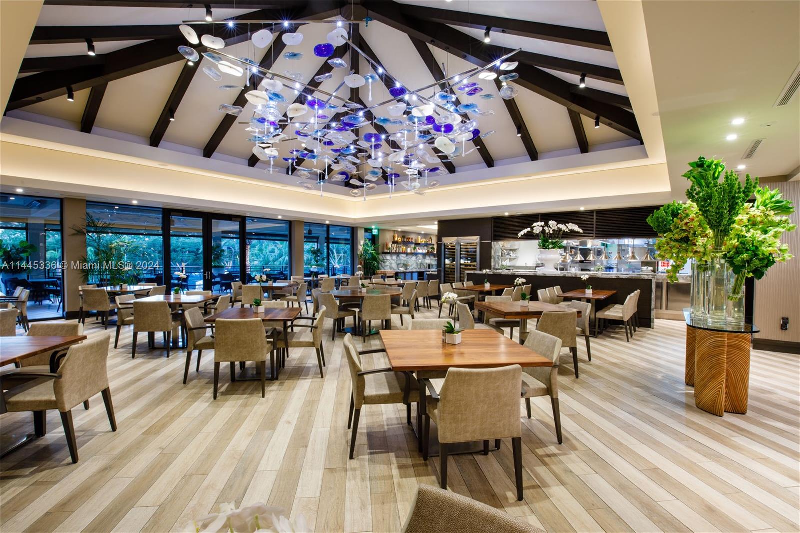 3000 Island Boulevard, Unit 2603 Aventura, FL 33160 - Photo 23 of 28 a group of people sitting at tables in a patio