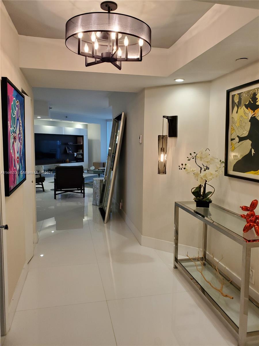 3000 Island Boulevard, Unit 2603 Aventura, FL 33160 - Photo 4 of 28 a view of a livingroom with furniture and a ceiling fan