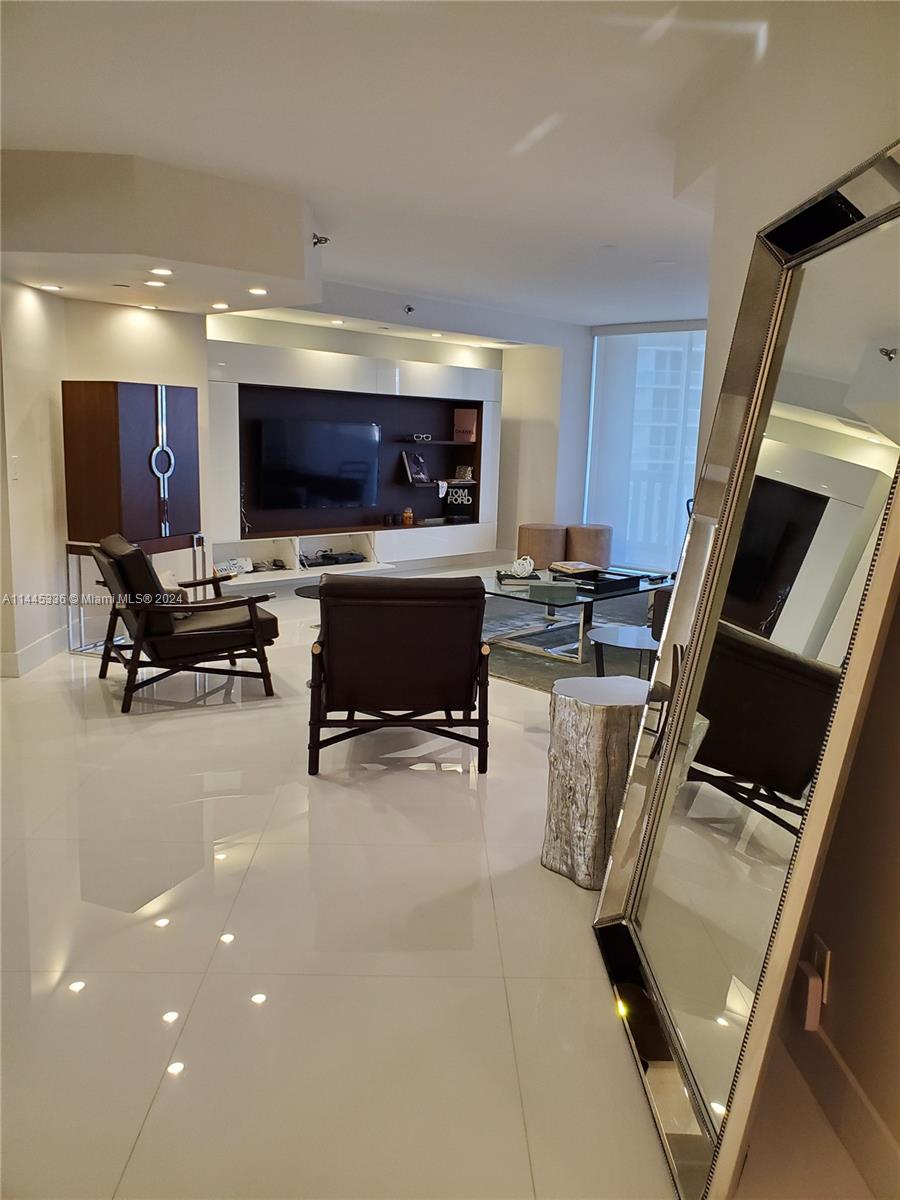 3000 Island Boulevard, Unit 2603 Aventura, FL 33160 - Photo 5 of 28 a living room with furniture and a flat screen tv