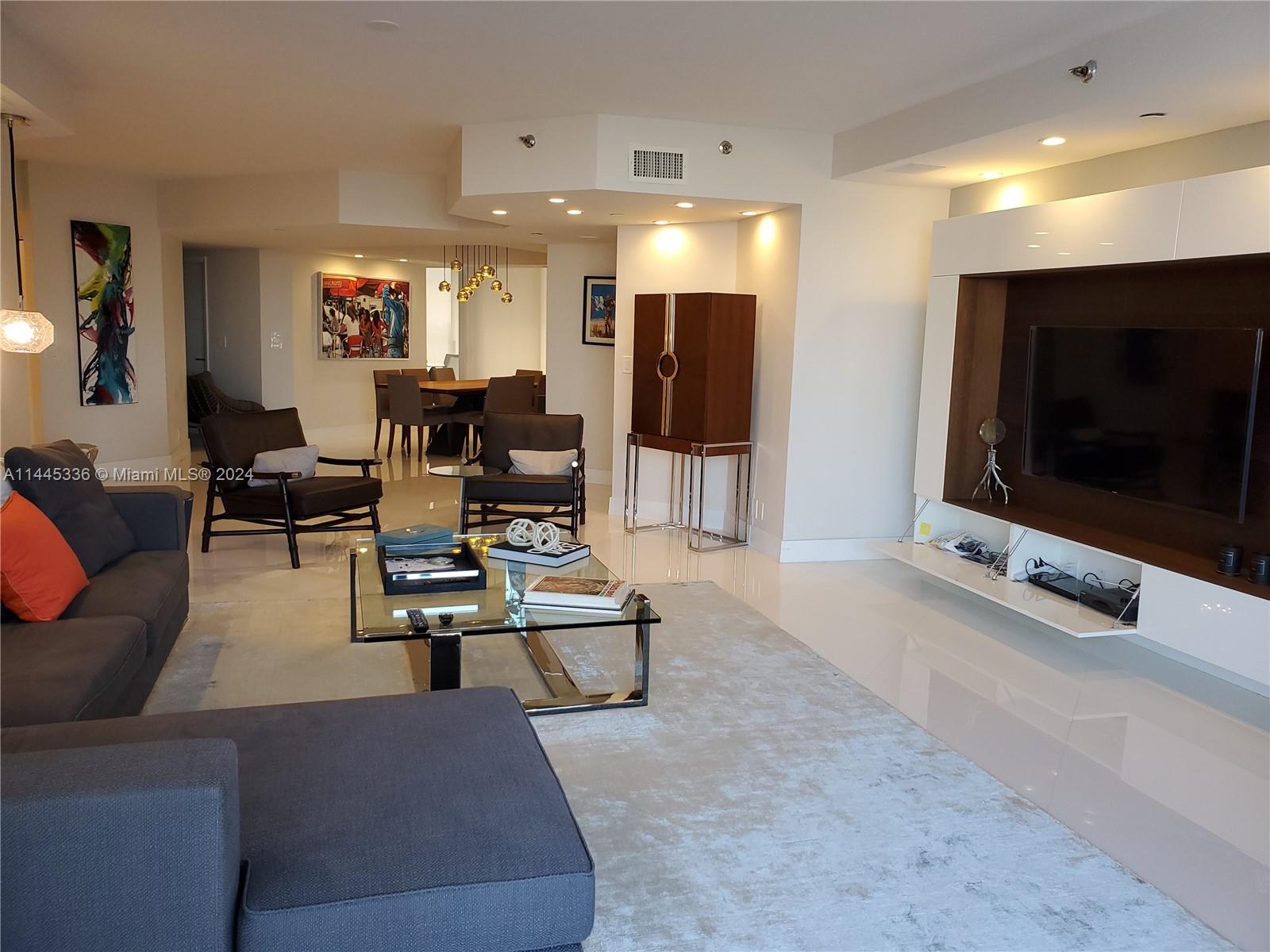 3000 Island Boulevard, Unit 2603 Aventura, FL 33160 - Photo 9 of 28 a living room with furniture and a flat screen tv