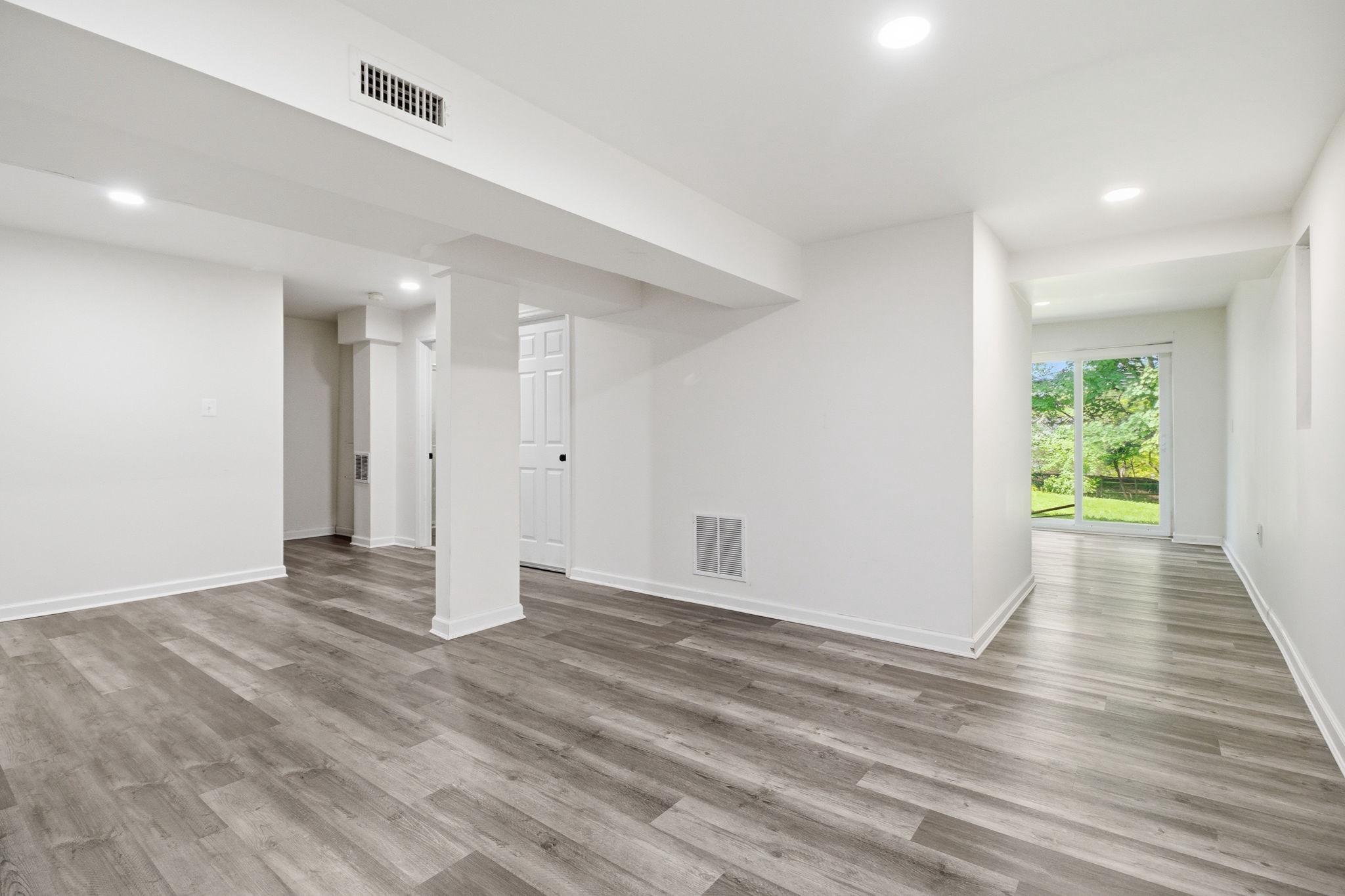 124 Englefield Drive Gaithersburg, MD 20878 - Photo 31 of 55 Walk-out basement with updated plank flooring