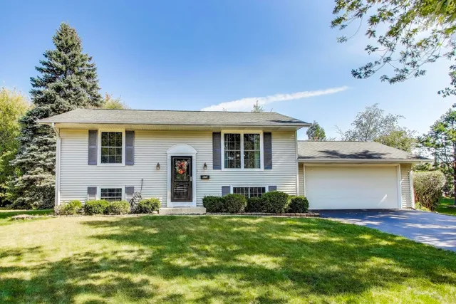 a view of a house with a backyard