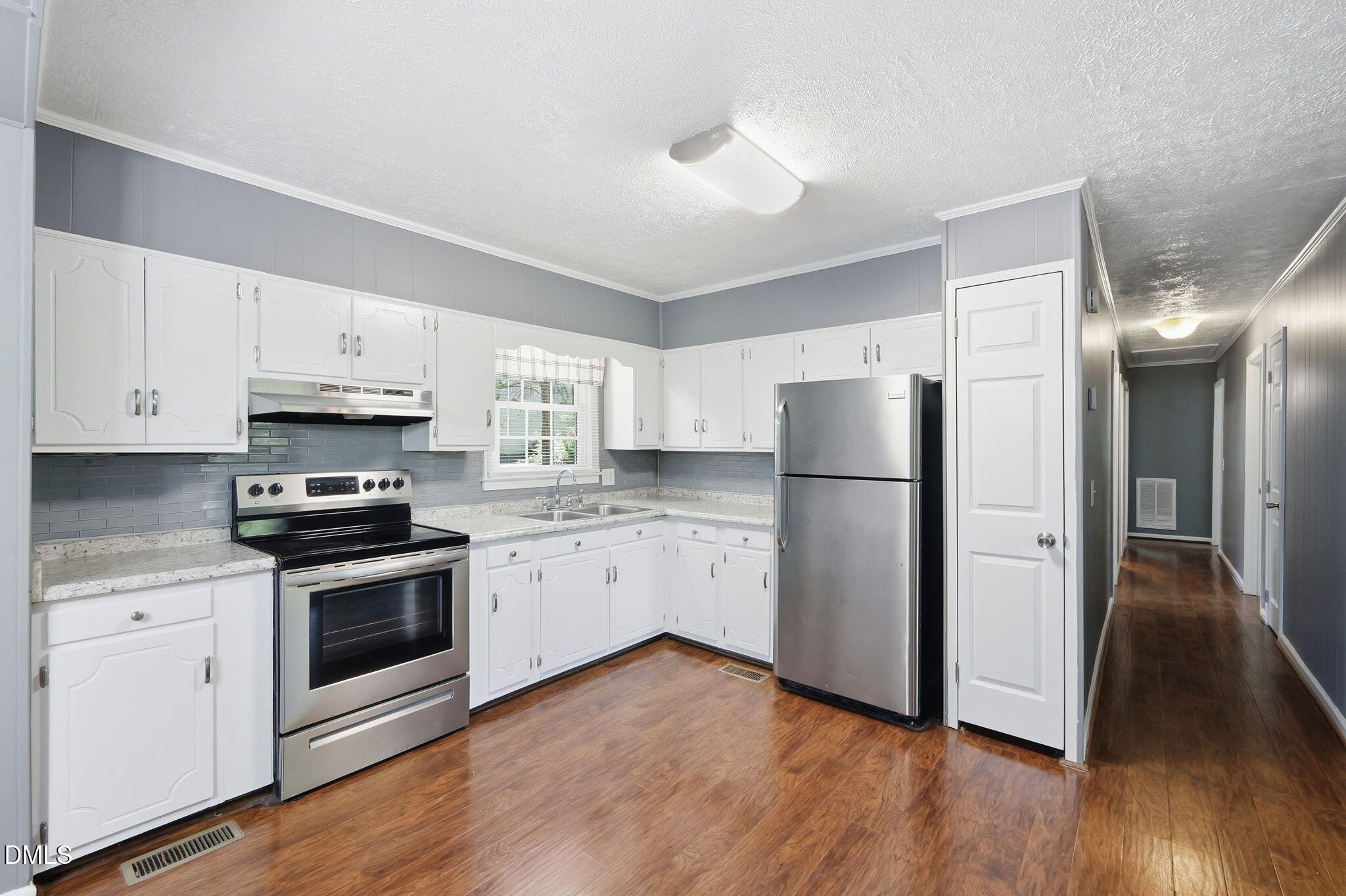 265 Shady Hill Circle Roxboro, NC 27573 - Photo 5 of 18 a kitchen with a refrigerator stove and wooden cabinets