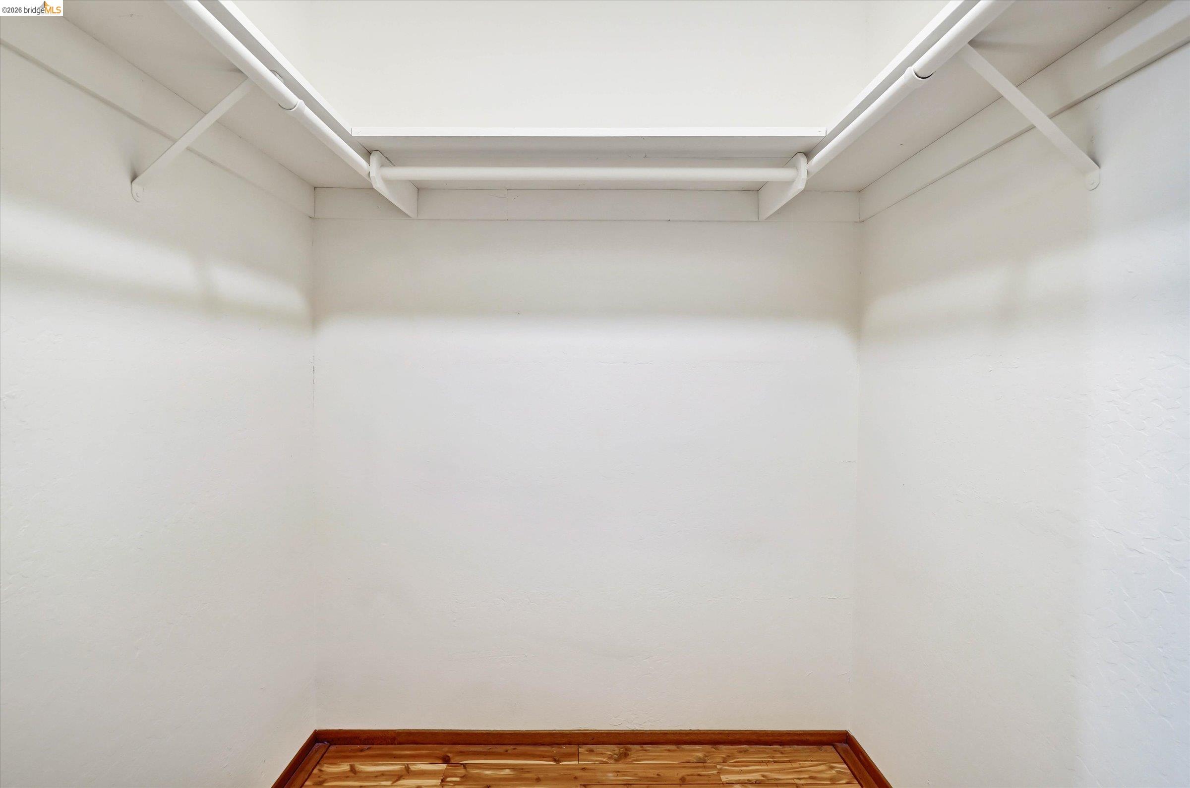 2826 Wright Avenue Pinole, CA 94564 - Photo 46 of 70 Closet storage featuring white shelving, hanging rods, and wood-finish flooring