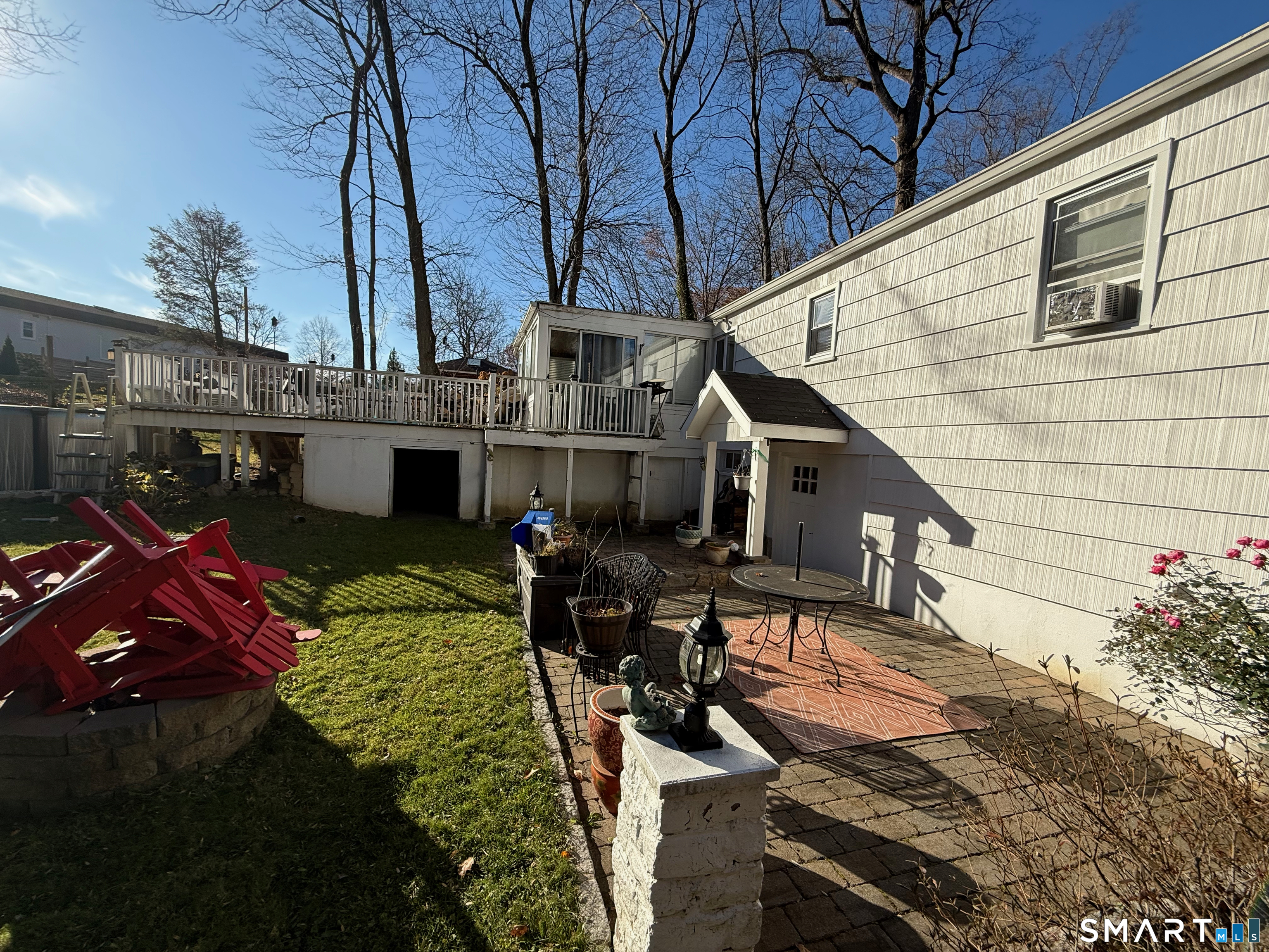 10 Purdy Road Norwalk, CT 06850 - Photo 4 of 21 a view of a patio with table and chairs with wooden floor and fence